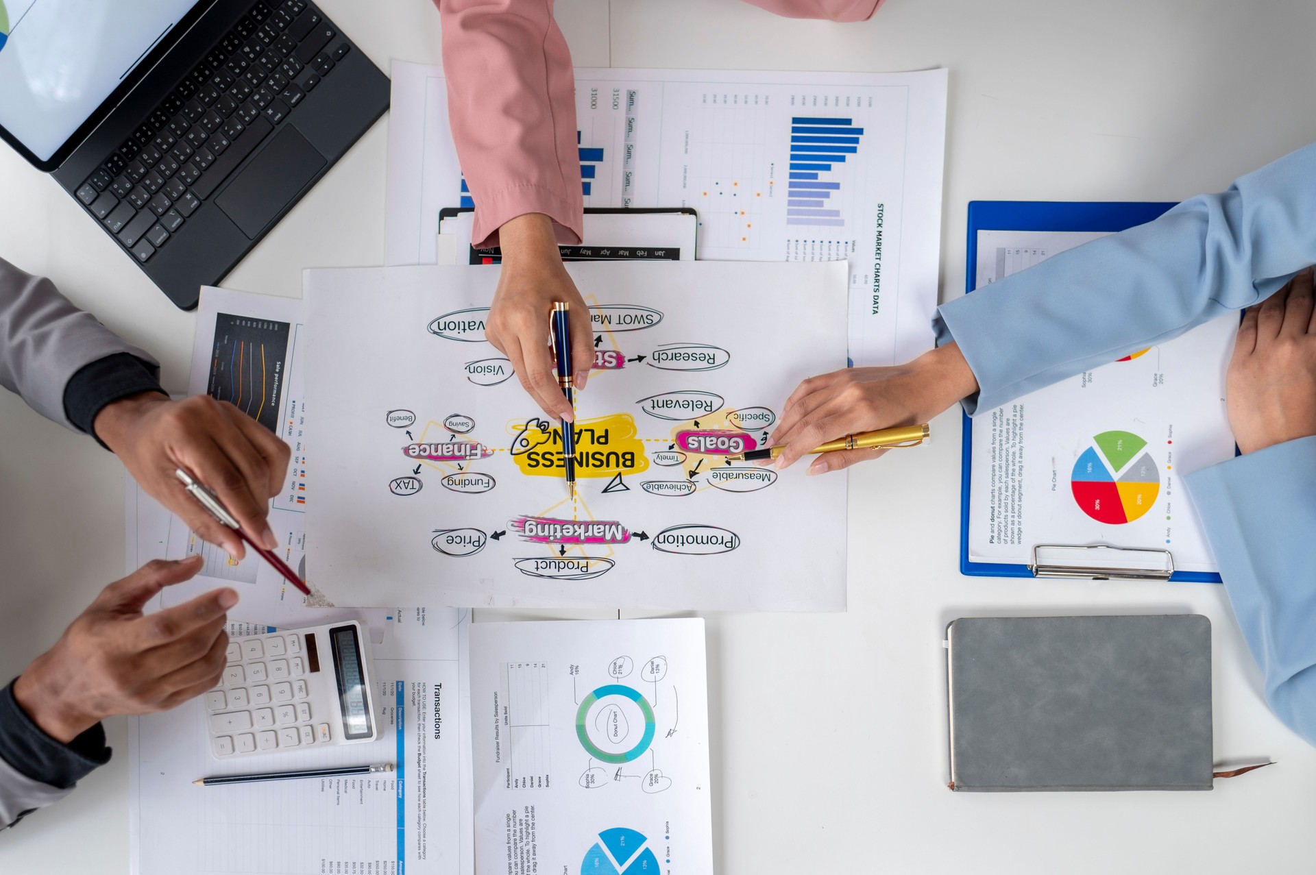 Business people working on a business plan using data analysis and charts
