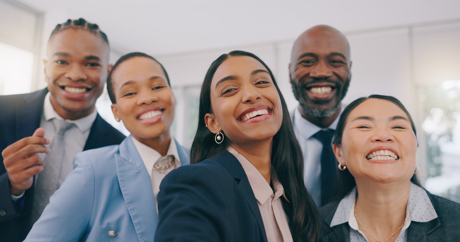 Happy business people, portrait and selfie for photography, picture or team building together at office. Face of employee group smile in diversity for community, teamwork or fun friends at workplace